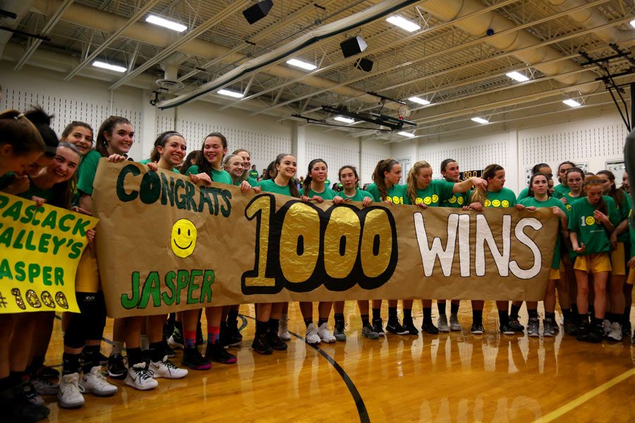 Players hold up a sign congratulating Jeff Jasper on his 1,000th win. Jasper joins a list of 41 other high school basketball coaches who have reached the 1,000 win milestone.  