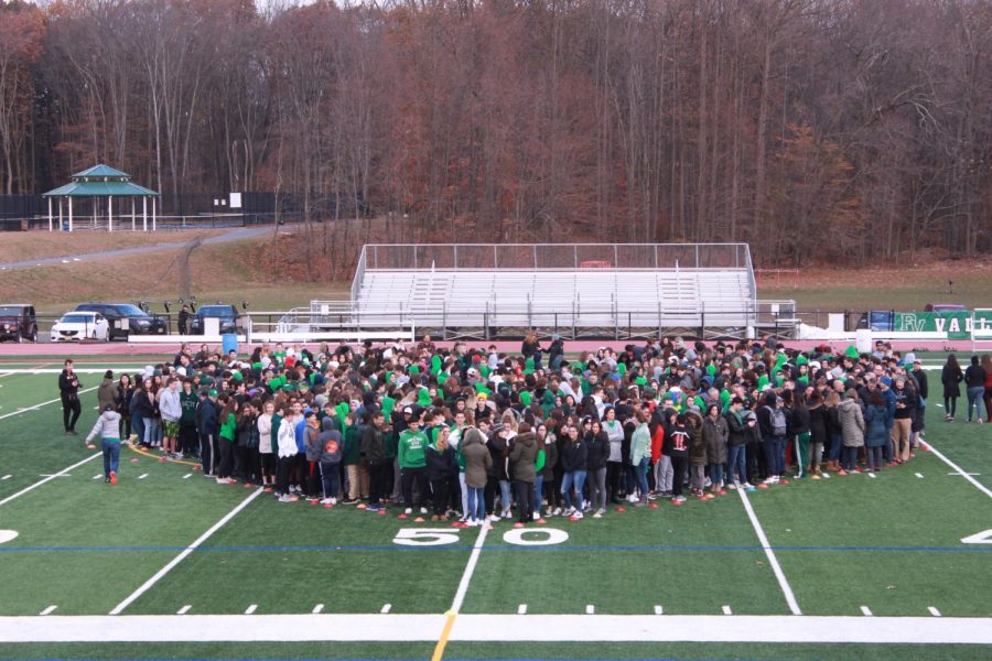 Students stand in the shape of a heart during the Movement of Unity.