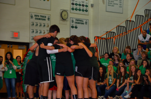 The student team huddles before its basketball game against the faculty during Wednesday's first Valley Cup assembly. The teachers won the game, and the seniors hold a slim lead in the points standings.