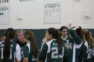 Andrew Lewis (in black) talking to PV in a huddle during a game. Lewis announced at his team's end of season dinner that this, his 21st season, would be his last as head coach. He will remain on as the freshman coach. 