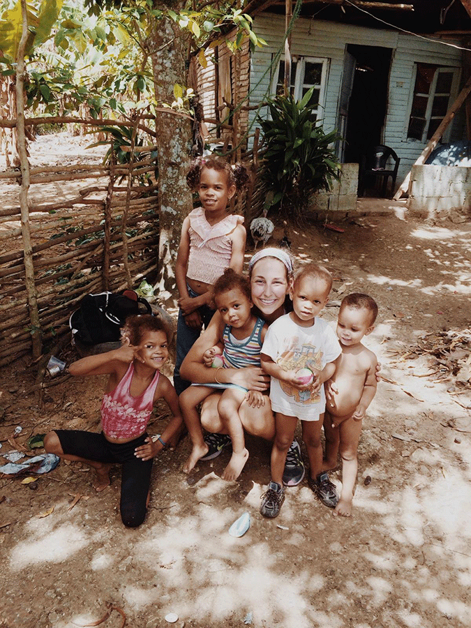 PV senior Jessica Powell poses with local children during a visit to the Domincan Republic. Powell has aided Domincan farmers by helping provide them microloans to purchase cows.