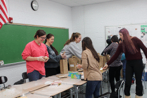 Members of PV Provide prepare bagged lunches recently to aid a local shelter. The organization will be holding its Sleep Out event May 16 on the PV Football Field.