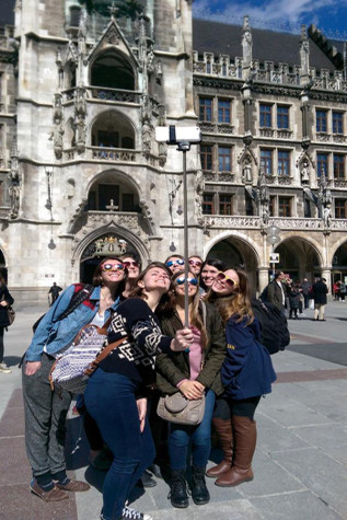 Students use a selfie stick to pose for their picture.