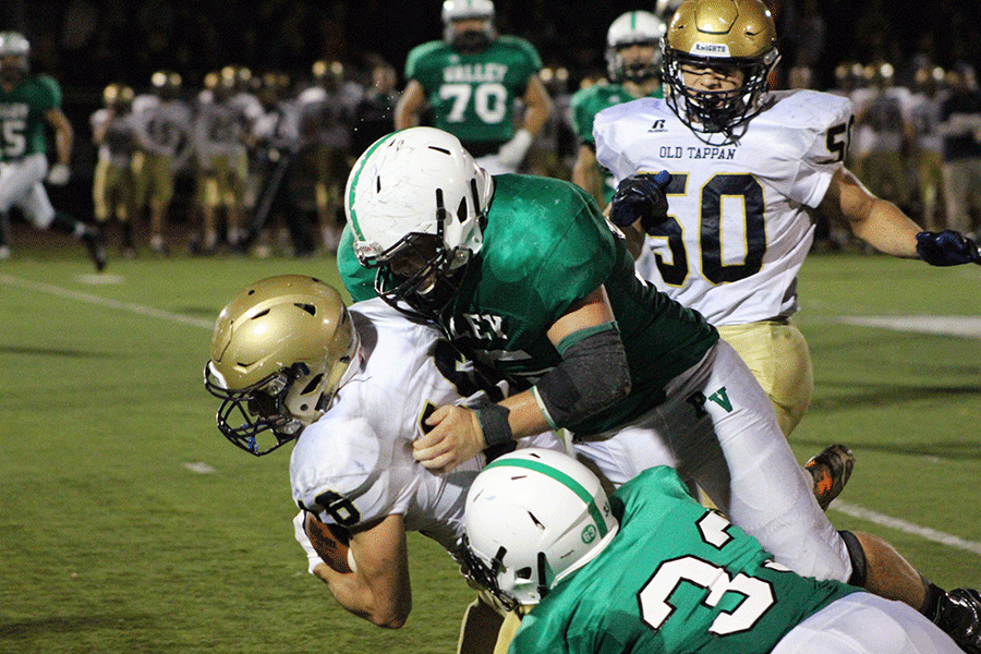 Tommy Uhl and Jake Giambona combine for a tackle during Pascack Valleys 42-14 loss to Old Tappan on Friday night.