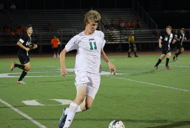 Michael Lin dribbling the ball towards goal. 