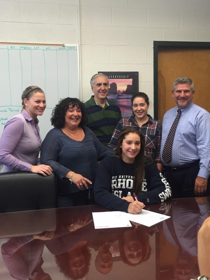 Alex Pleasic signs her National Letter of Intent to attend the University of Rhode Island. Pictured from left to right is Ms. Jessica Sachs, Mrs. Pleasic, Alex Pleasic, Mr. Pleasic, Sydney Pleasic and Principal Mr. Tom DeMaio