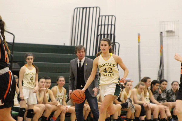 Sophomore Kelly Petro dribbles the ball up the court in front of coach Jeff Jasper during the teams 64-16 county tournament win over Fort Lee
