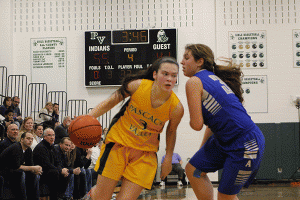 Sophomore Kelly Smith drives on a Holy Angels player during Saturdays game