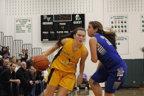 Sophomore Kelly Smith drives on a Holy Angels player during Saturdays game