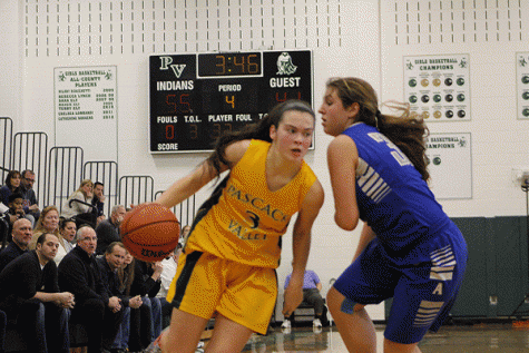 Sophomore Kelly Smith drives on a Holy Angels player during Saturday's game