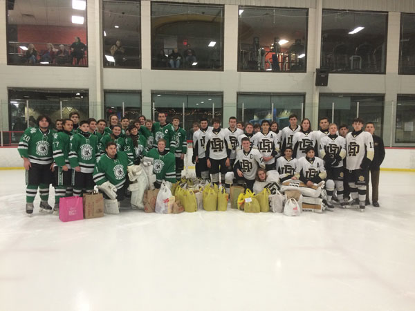 The Pascack Valley and River Dell hockey teams gather on the ice after the food drive ran by both teams. 