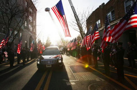 The hearse comes down the center of Westwood surrounded by the 343 American flags that the FDNY provided. 
