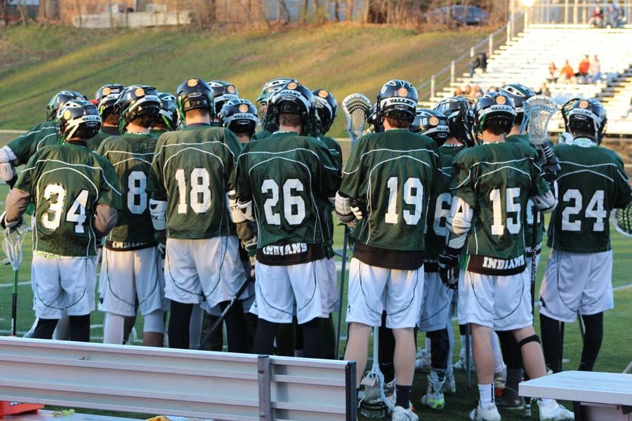 Pascack+Valleys+boys+lacrosse+team+in+a+pregame+huddle+before+the+teams+first+annual+charity+classic+against+rival+Pascack+Hills.+The+players+are+all+wearing+orange+Lax+4+Zack+stickers+on+their+helmets.+