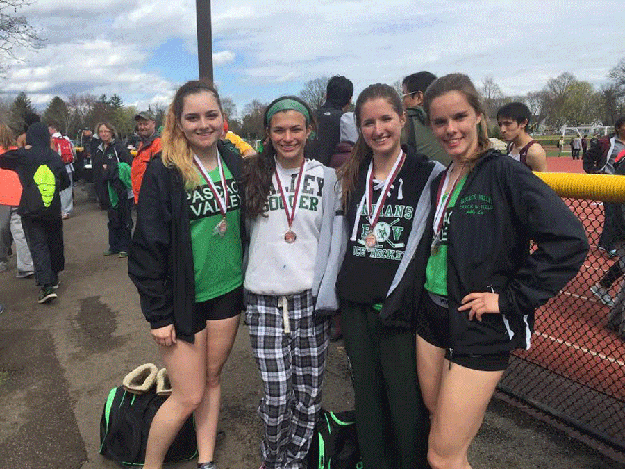 Seniors Ashley Evans (second from left) and Nikki Criscuolo (second from right) pose with their medals after finishing fourth at last springs Pawlowski Relays. Evans and Criscuolo are two of PVs best runners, and look to propel the girls to another winning season