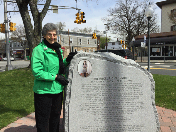 Mrs. Rosemarie DAlessandro stands next to the plaque remembering her daughter Joan.