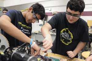 Suraj Pandya (left) and Salvatore Sileo work on the robot.