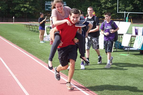 Sophomores, Liam Sandt and Lisa Agranov, run on the track.  