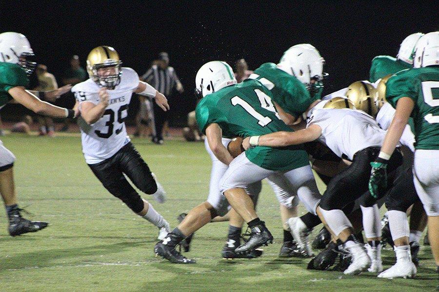 Matt Urrea (14) fights through a tackle. Urreas totaled 268 rushing yards through his first two games this year.