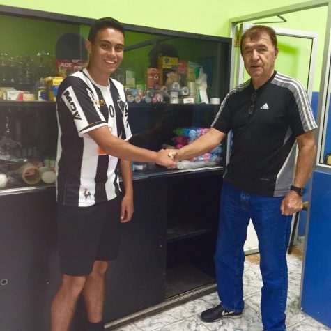 Emilio Quevedo shaking hands with the owner of the club that he donated supplies to on his first visit, Dušan Drašković. 