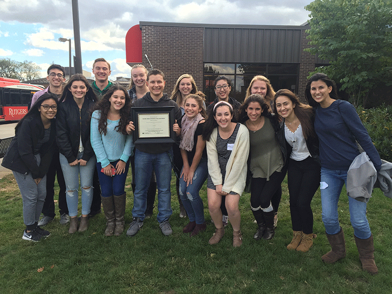 The Smoke Signals staff poses for a picture with a certificate from the GSSPA in 2016.