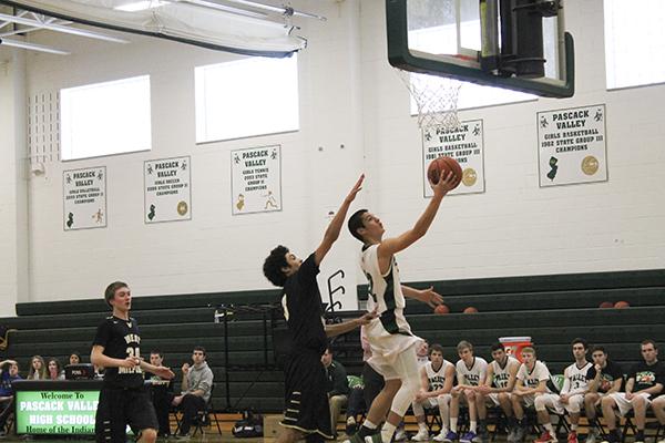 Pascack Valley point guard Legend Dominguez drives to the hoop against West Milford.