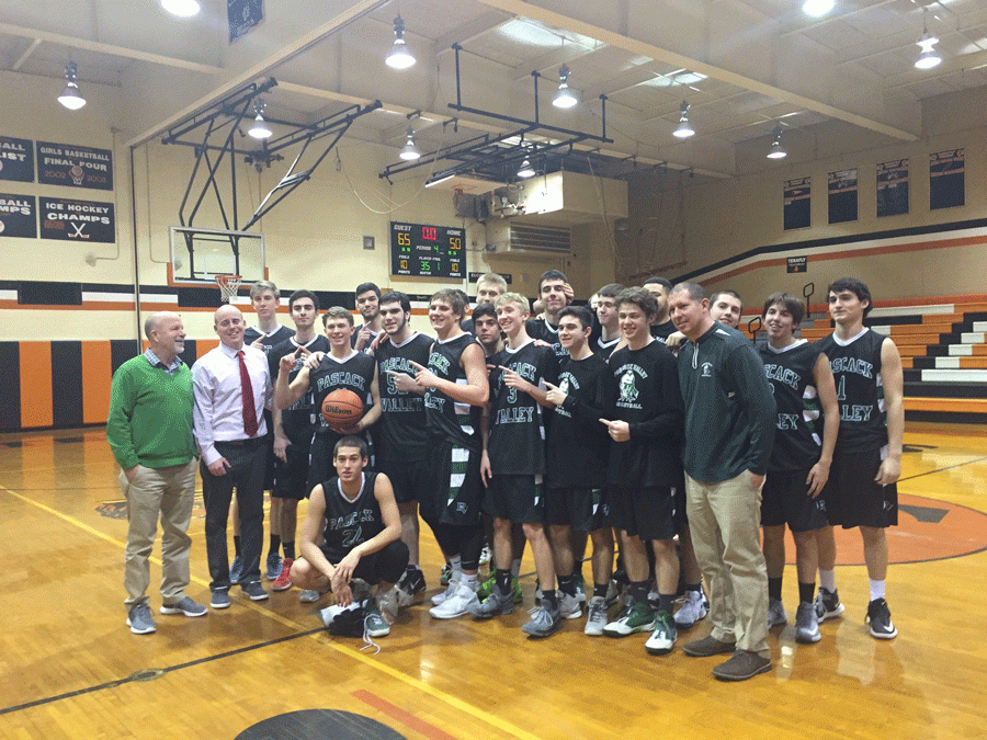 The Indians and coach Al Coleman (in white) celebrate with senior Matt Vasel (holding ball) after he reached 1000 points for his career during Tuesdays 65-50 victory over Tenafly.