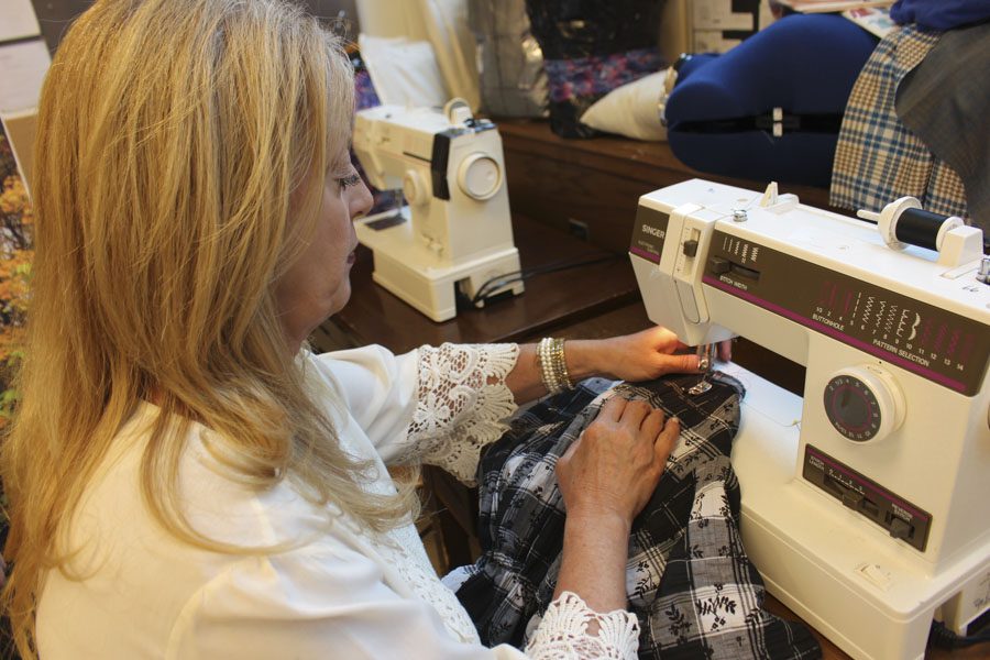 Ms. Annette Molino sews a shirt that had been made from textiles. Before PV, she used to work with textiles as a manager of different outlet stores. 