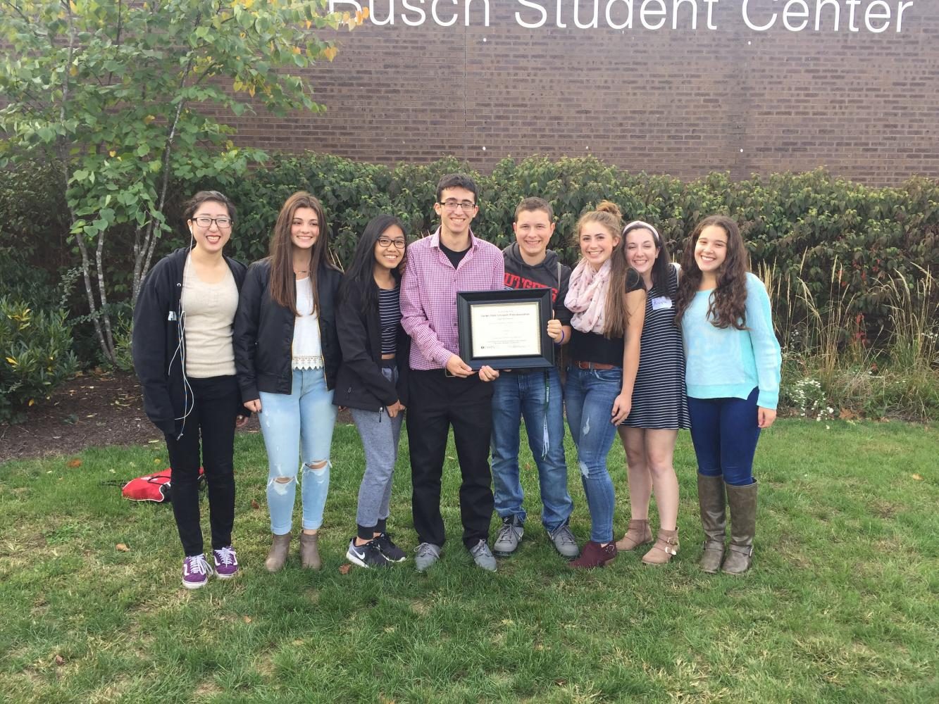 Pictured above (from left): Jamie Ryu, Sarah Schmoyer, Curstine Guevarra, Jake Aferiat, Kyle Comito, Madison Gallo, Kayla Barry, and Lauren Cohen. The 2016-2017 Smoke Signal Editorial Staff presents their plaque for being named the GSSPA’s Distinuighed Journalism Program for
New Jersey’s Division B at last years GSSPA Conference.