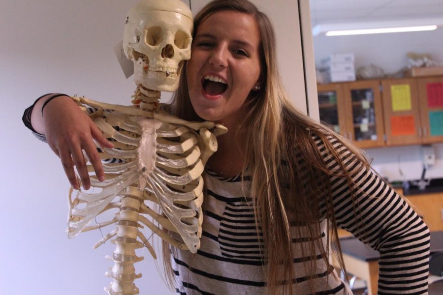 Kyra Gynegrowski poses with a skeleton. Kyra interns at Advanced Orthopedics & Sports in Nanuet, N.Y.
