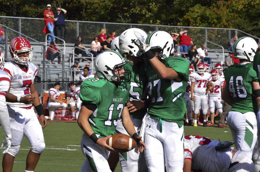 Greg Zoll (13), Jake DeMilia (5) and Jake Ciocca (27) after Zoll scores a touchdown.