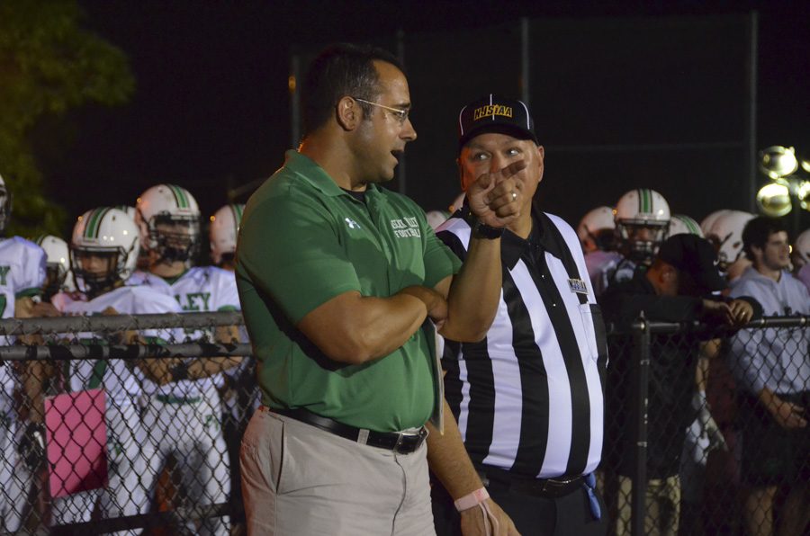 Coach Len Cusumano talks to one of the referees during halftime.