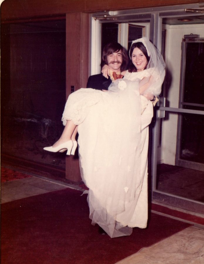 Jeff Jasper carries his bride, Lois Jasper, on their wedding day on March 5, 1972. 