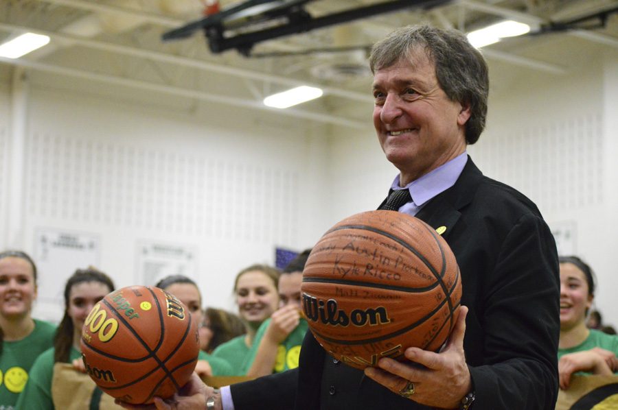 Mr. Jeff Jasper holds up the balls given by the girls basketball team and Dream Team.