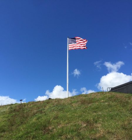 American flag stands up on a hill.