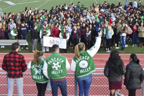 Student organizers try to get the attention of their fellow students as they gather on the football field.