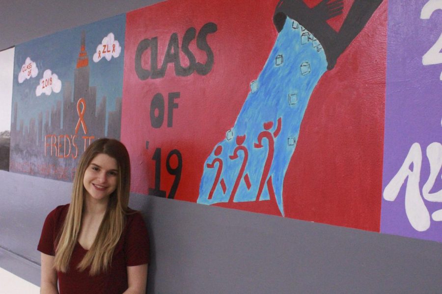 Sofia Urbaniak with the class of 2019's mural. The class of 2019's class cause is ALS, a cause close to Sofia's heart. 