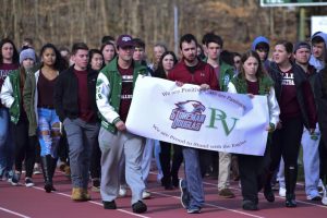 Pascack Valley student organizers lead their fellow students in a lap around the track in memory of the victims of the Parkland High School shooting.