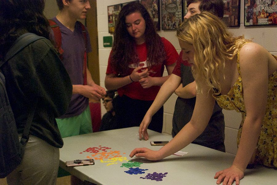 Students from the LGBTQ club hand out stickers for students participating in the Day of Silence event to wear.