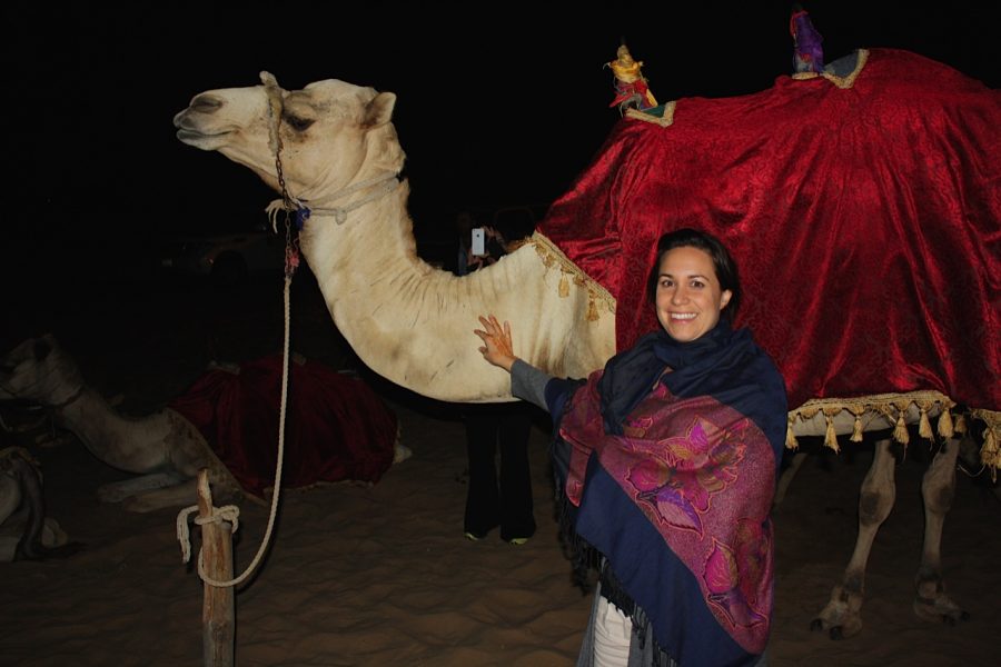 Angie+DeLima+standing+with+a+camel+in+Dubai.