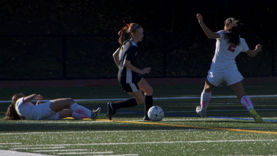 Paige Skene makes her way around defenders to approach the goal.