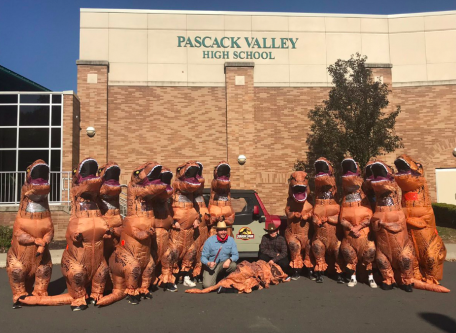 A group of seniors dressed up as T-rexes with teacher Mr. Michael Sherman as Dr. Alan Grant from Jurassic Park.