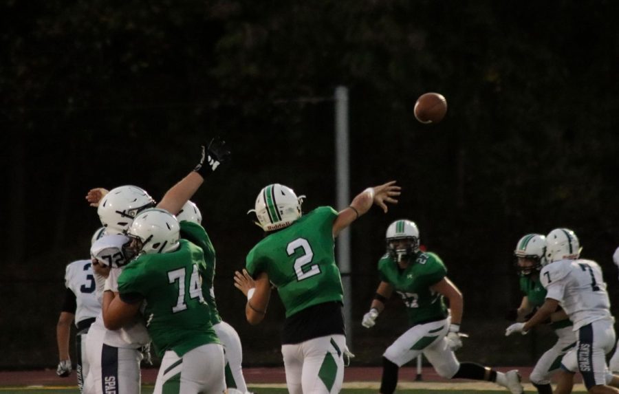 Quarterback Stephen Begen throws the ball to his receiver.