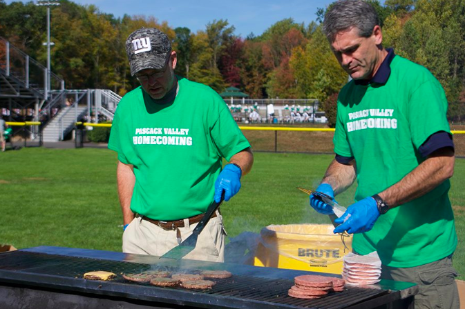 Pascack Valley physics teacher Bill Koenig and physics and technology and Honors Engineering Design teacher Jim Kennedy grill hamburgers during homecoming. This year, homecoming will be held from 11:30 a.m. to 3:30 p.m. on Saturday, Sept. 28.