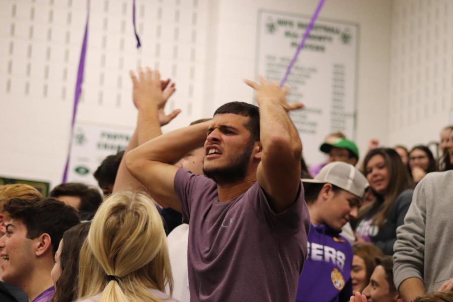 Senior Andrew Martinez cheers on his grade during the dodgeball game. 