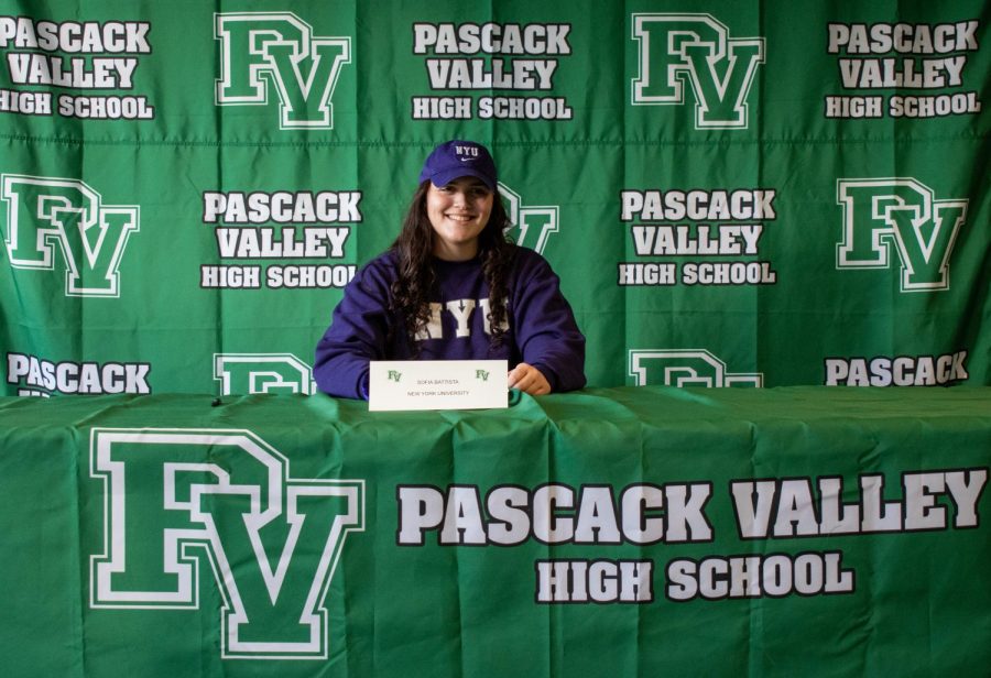 PV senior Sofia Battista at the podium of Pascack Valleys winter signing day ceremony, where she officially committed to NYU for basketball.