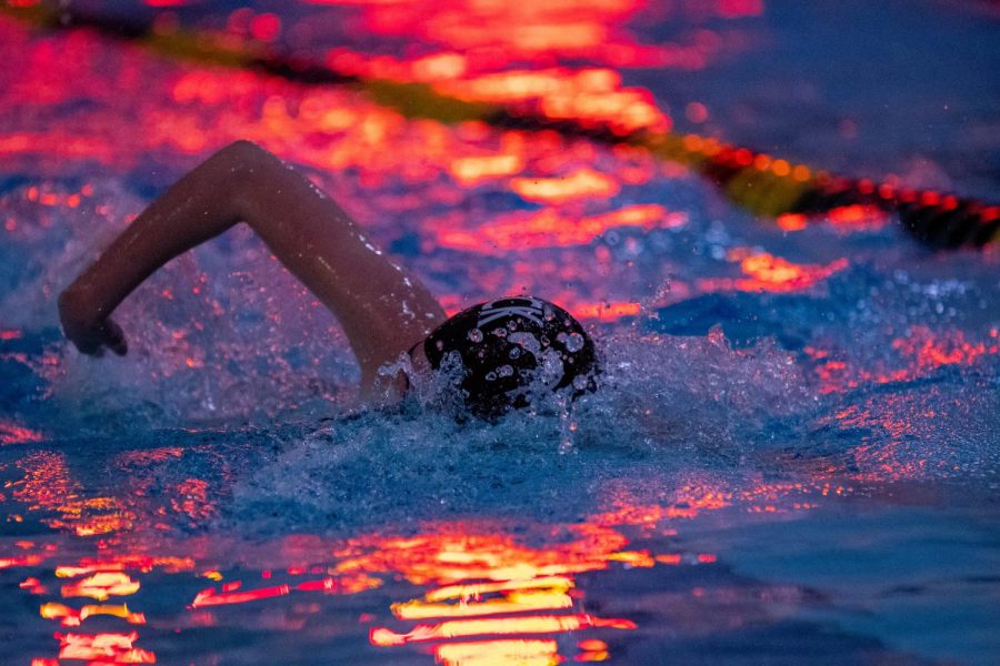 A+PV+swimmer+cuts+through+the+water+under+the+lights+of+the+scoreboard.+The+girls+swim+team+will+utilize+its+depth+in+2021%2C+having+27+members.