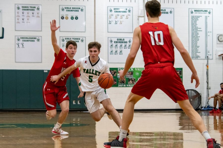Jake Wolf dribbles through the defense. The PV boys basketball team begins its season later than expected.