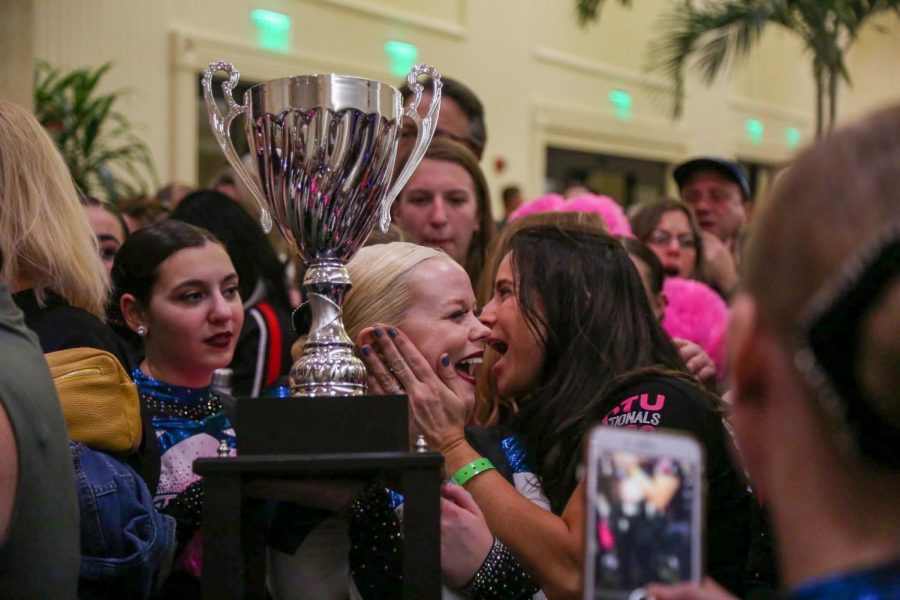 Senior dance team captain Sarah Viceconte holds the trophy after winning the National Championship in Small Pom.