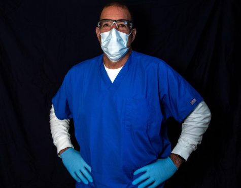 River Vale resident Tom Donofrio wears scrubs, googles, gloves, and a mask. He works for the Visiting Nurse Association as a physical therapist and treats patients at their homes. 