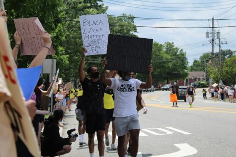 Protesters walk along Old Tappan Road. Many held signs advocating for the Black Lives Matter movement. 